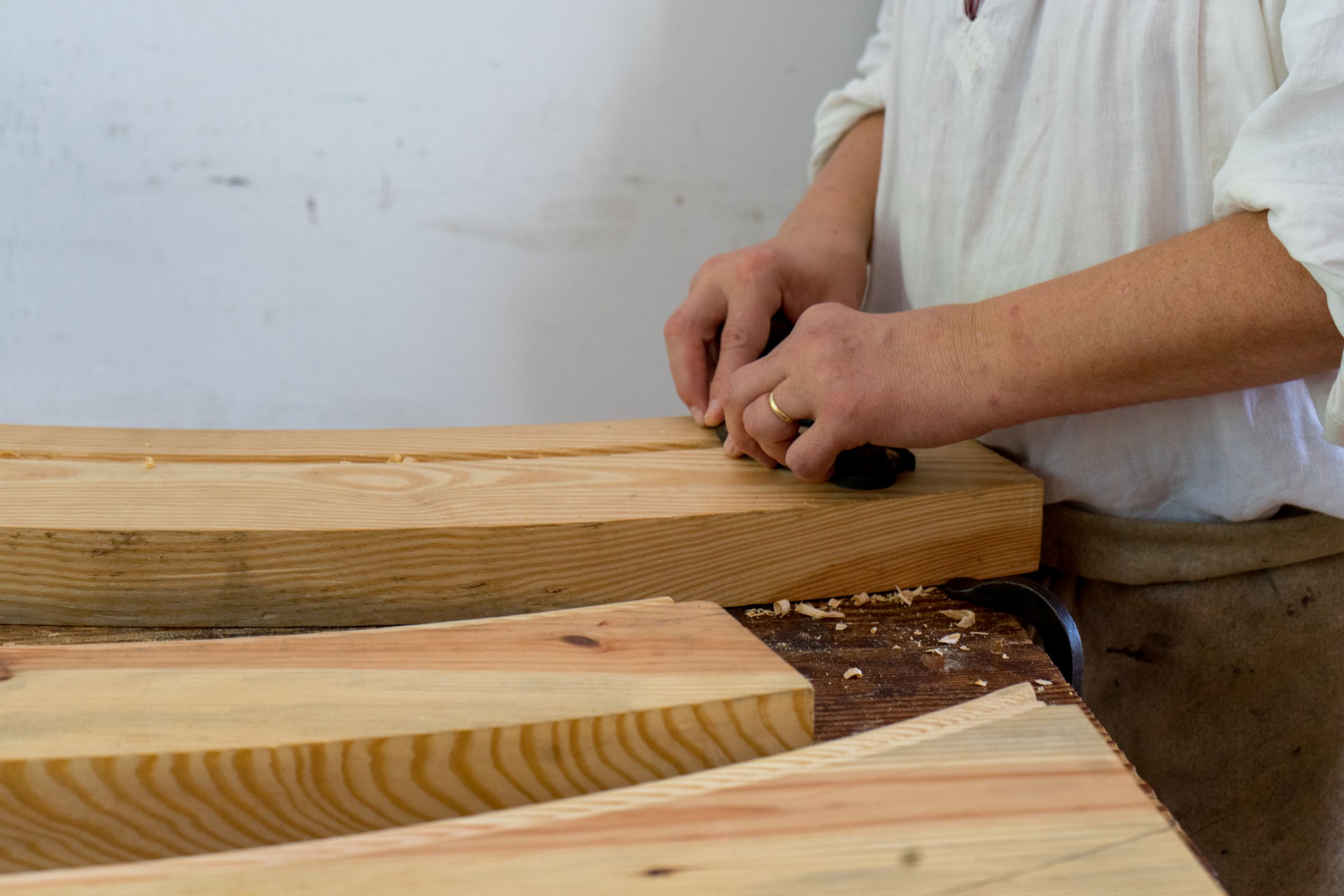A gunsmith's hands at work on a stock